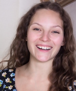 Smiling brunette girl goes to expose hairy vagina on stairs