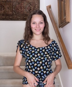 Smiling brunette girl goes to expose hairy vagina on stairs