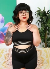 Chubby Asian mom with glasses smiles while showing her hairy pussy