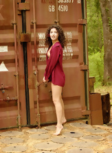Slim wife with wavy hair and hairy pussy stays naked near container