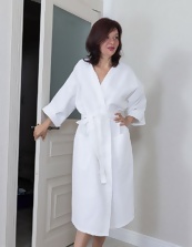 Milf in a white robe is comfortable after showering on the bed to fondle her hairy pussy with a toy